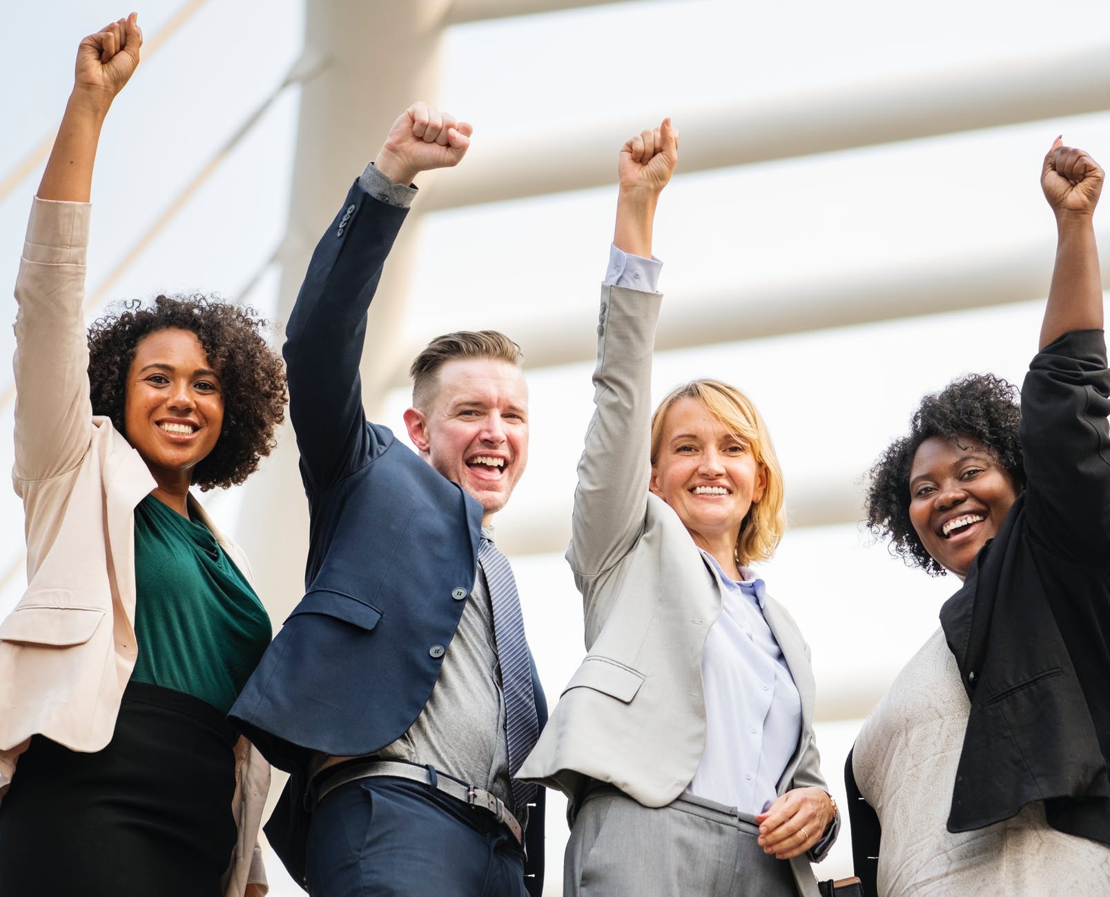 group of people raising right hand