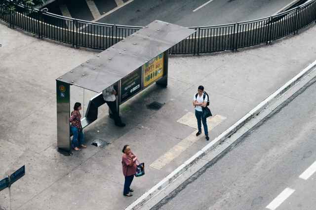 aerial photo of people on waiting shed