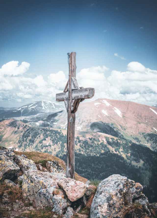 gray cross on mountain