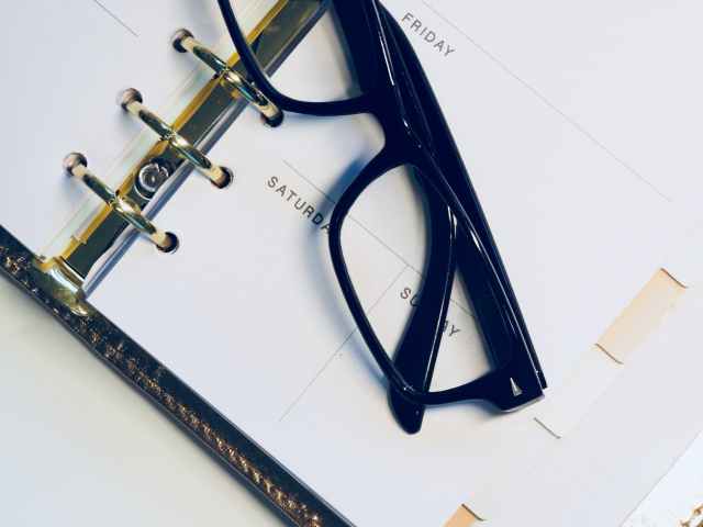 black framed wayfarer style eyeglasses on white surface