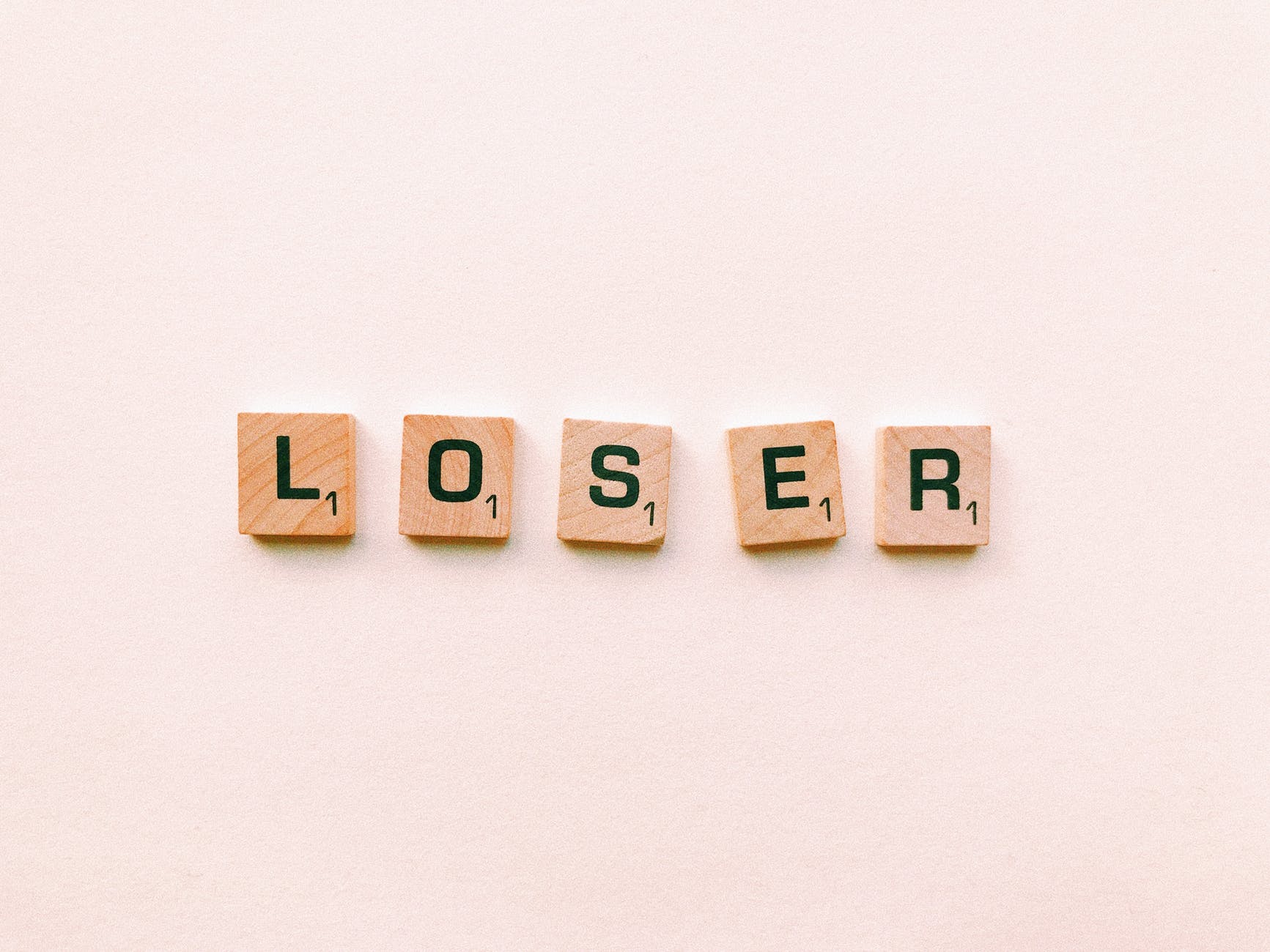 closeup photography of loser scrabble letter