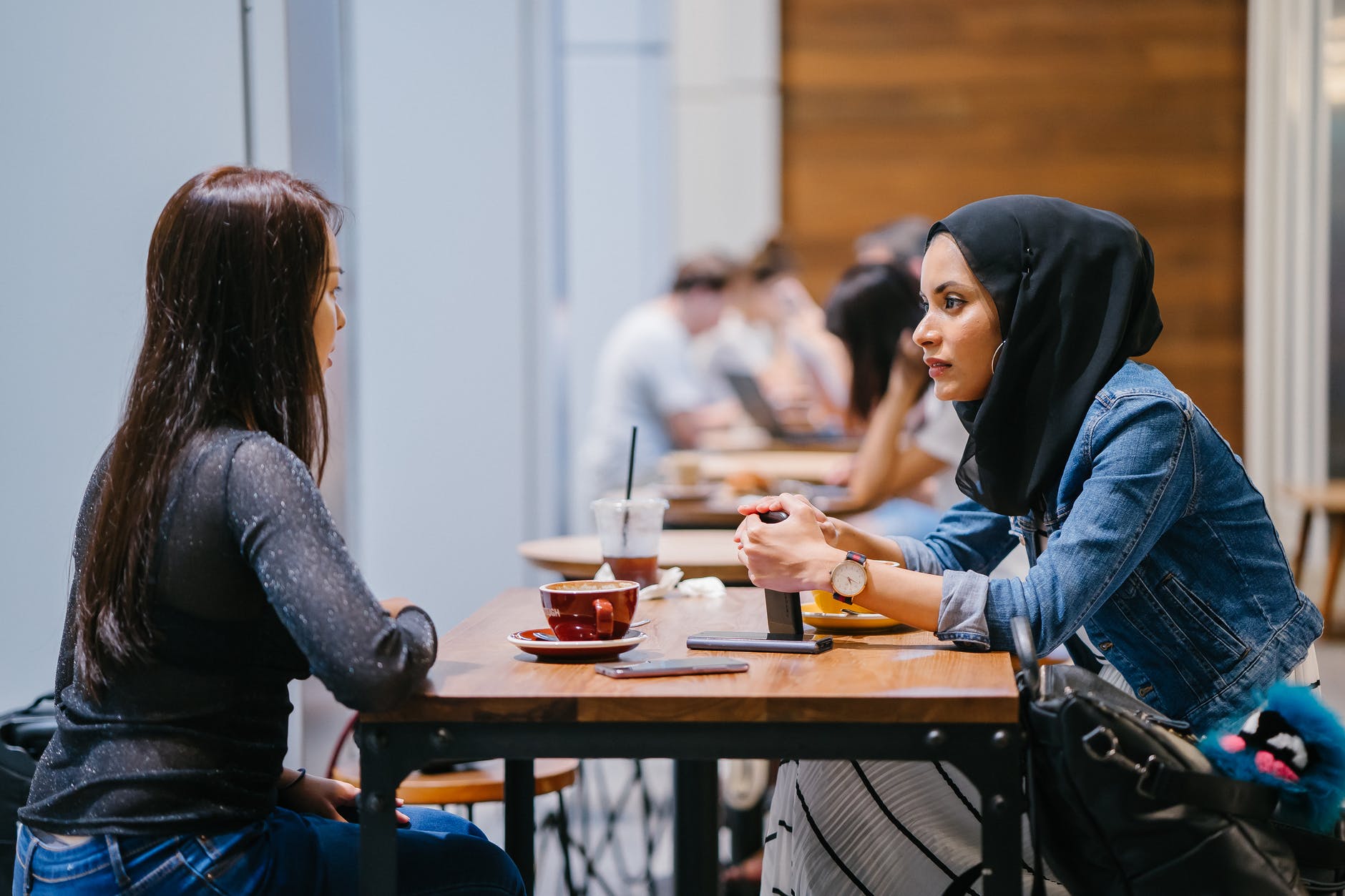 people sitting beside tables indoors